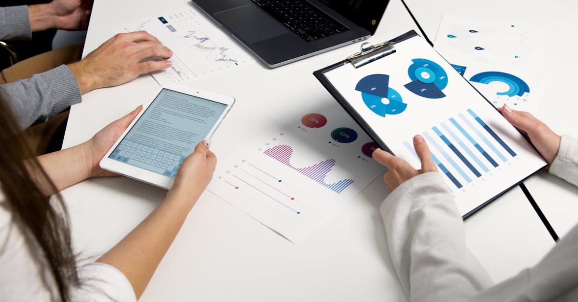 team-analyzing-financial-charts-and-digital-reports-during-a-business-meeting